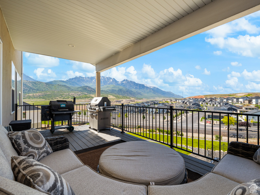 Balcony with grilling area, a mountain view, and a residential view