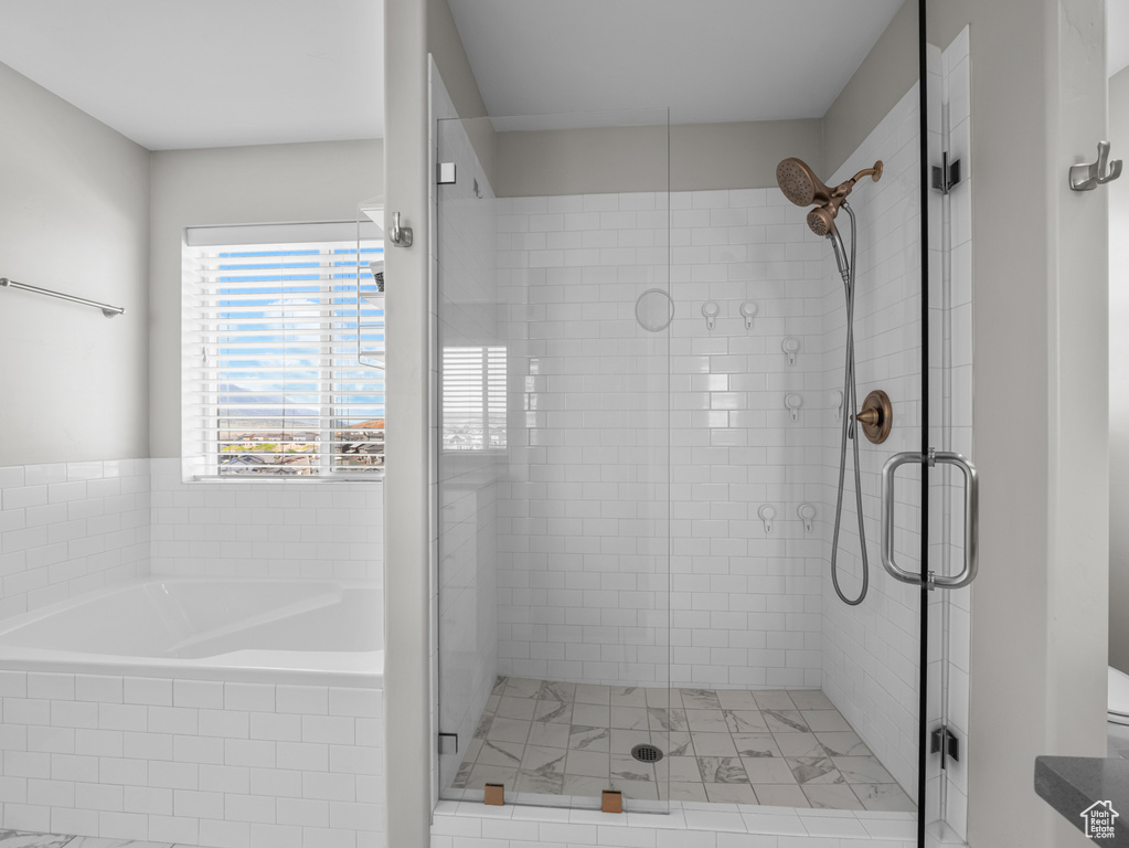 Full bath with a stall shower and a bath