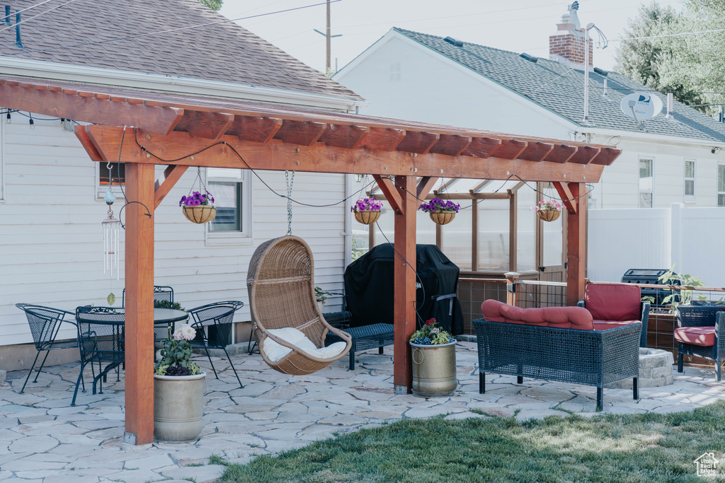 View of patio featuring a pergola, a grill, and an outdoor living space