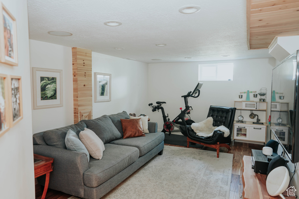 Living area with wood finished floors and recessed lighting