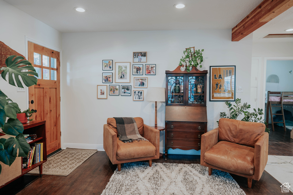Living area with recessed lighting, beamed ceiling, baseboards, and wood finished floors