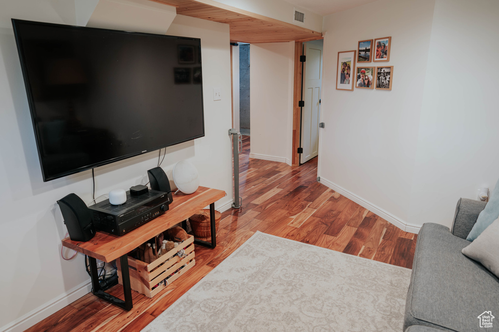 Living area with wood finished floors and baseboards