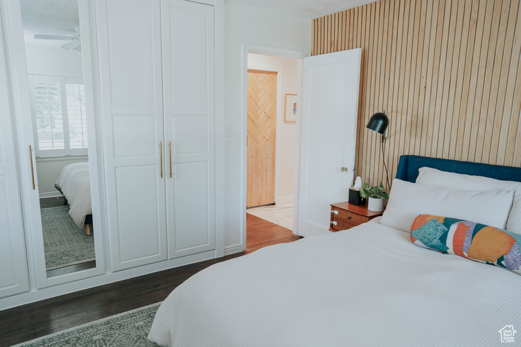 Bedroom featuring dark wood-style floors and baseboards