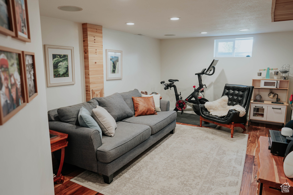 Living area with wood finished floors and recessed lighting