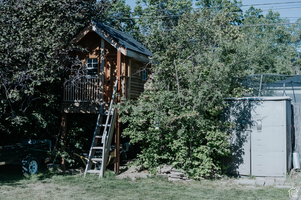 View of side of property with a wooden deck