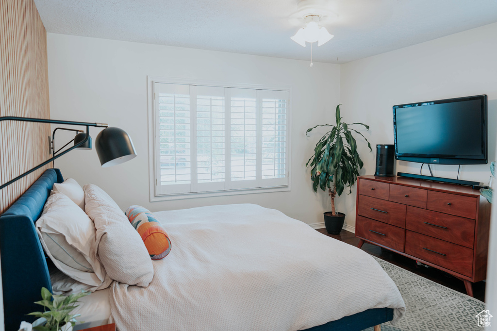 Bedroom with baseboards and wood finished floors