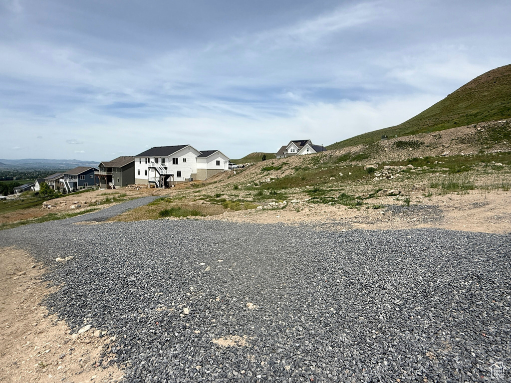 View of dirt / gravel road featuring a residential view