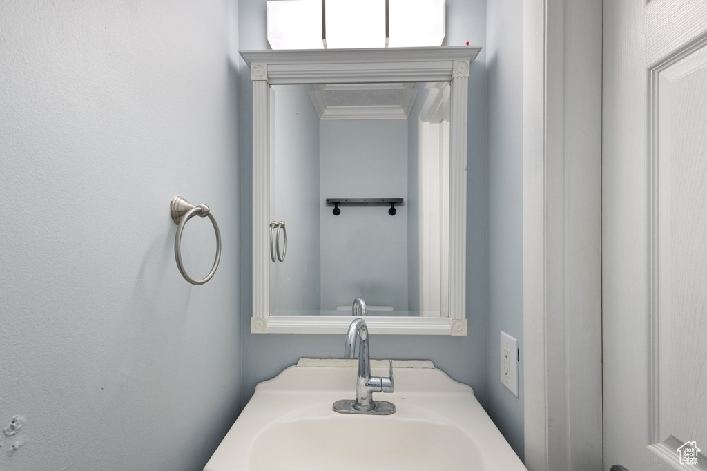 Bathroom with a sink and crown molding