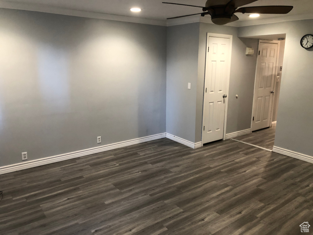 Spare room featuring ceiling fan, baseboards, recessed lighting, crown molding, and dark wood-style floors
