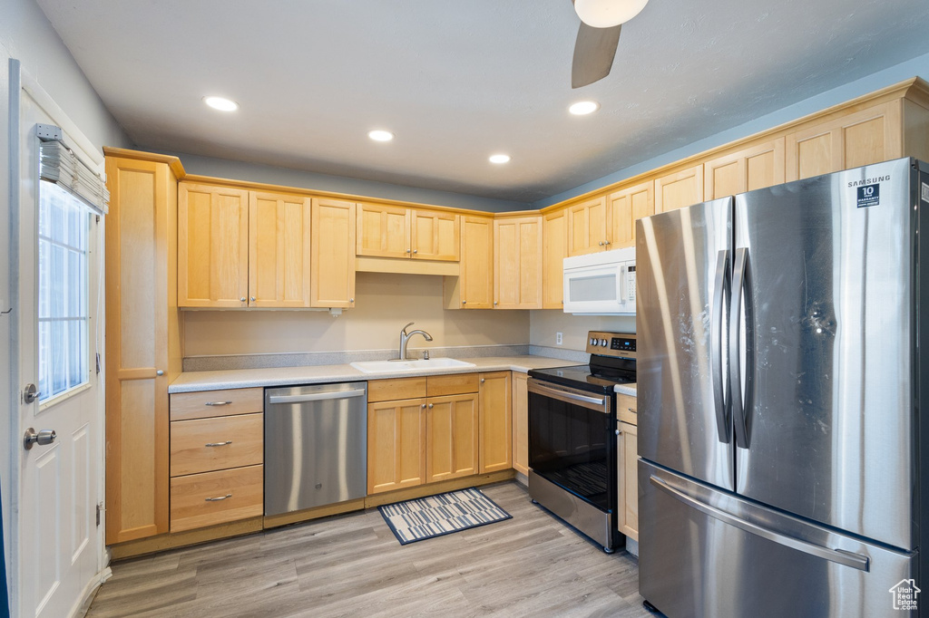 Kitchen featuring stainless steel appliances, light brown cabinets, light countertops, recessed lighting, and light wood-style floors