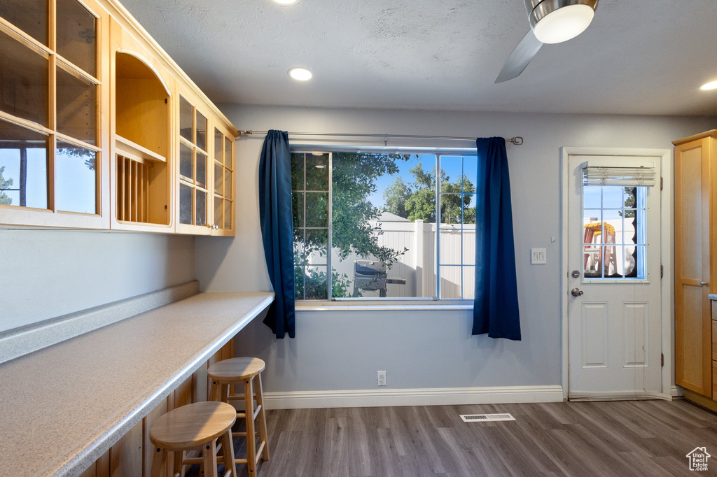 Unfurnished dining area featuring wood finished floors, a ceiling fan, and recessed lighting
