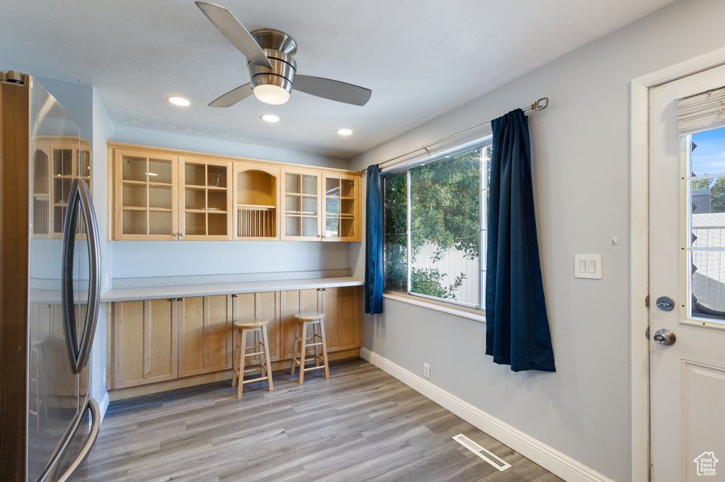 Dining area featuring light wood finished floors, plenty of natural light, ceiling fan, and recessed lighting