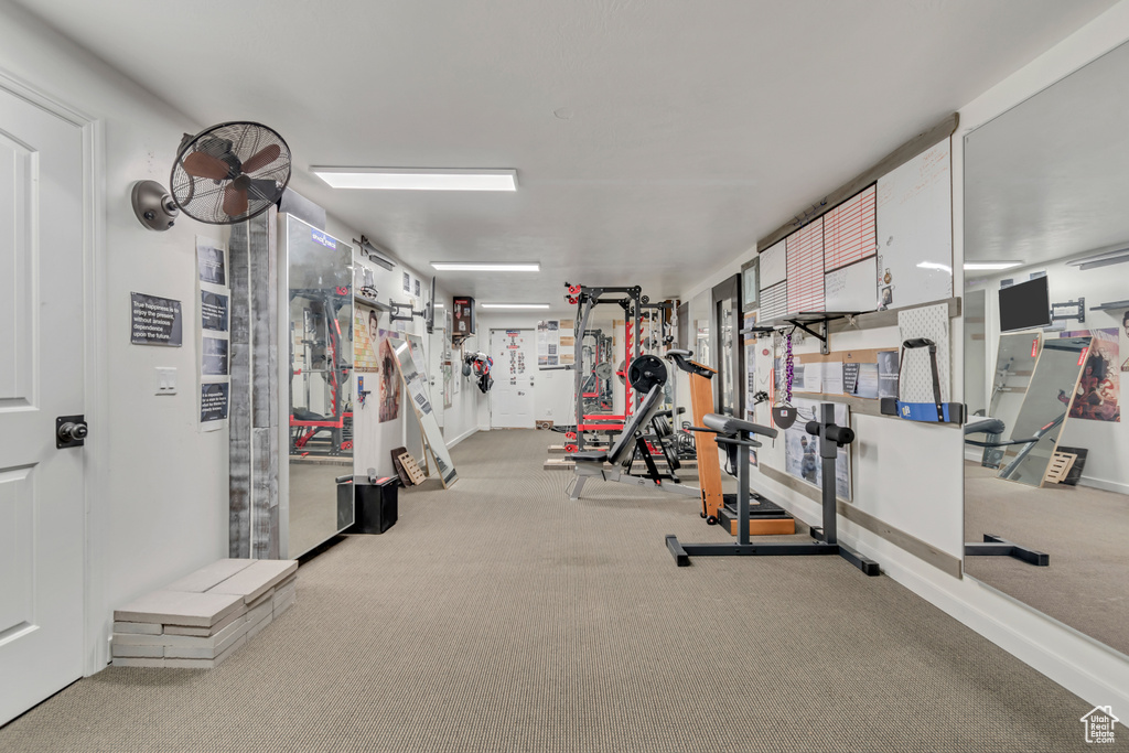 Workout area with carpet flooring and baseboards