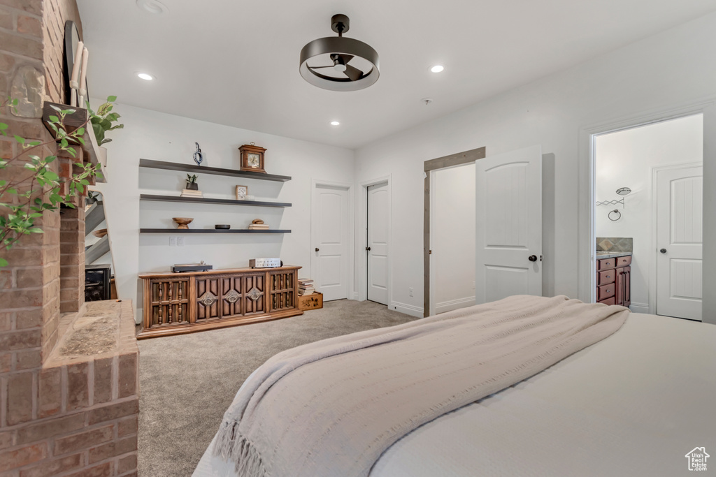 Carpeted bedroom with recessed lighting and connected bathroom