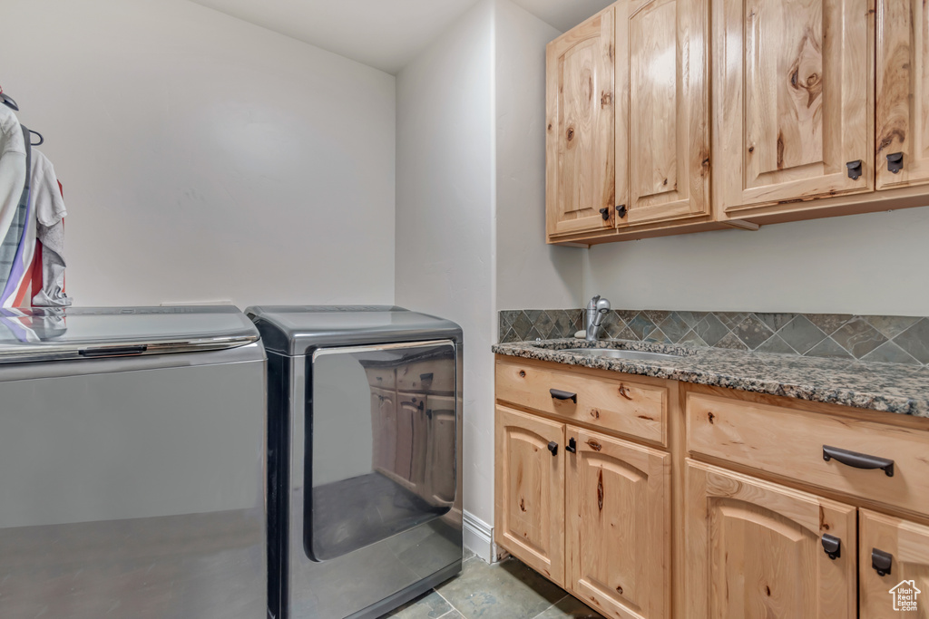 Laundry room featuring washer and dryer and cabinet space