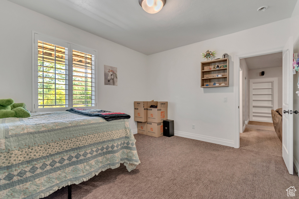 Carpeted bedroom with baseboards