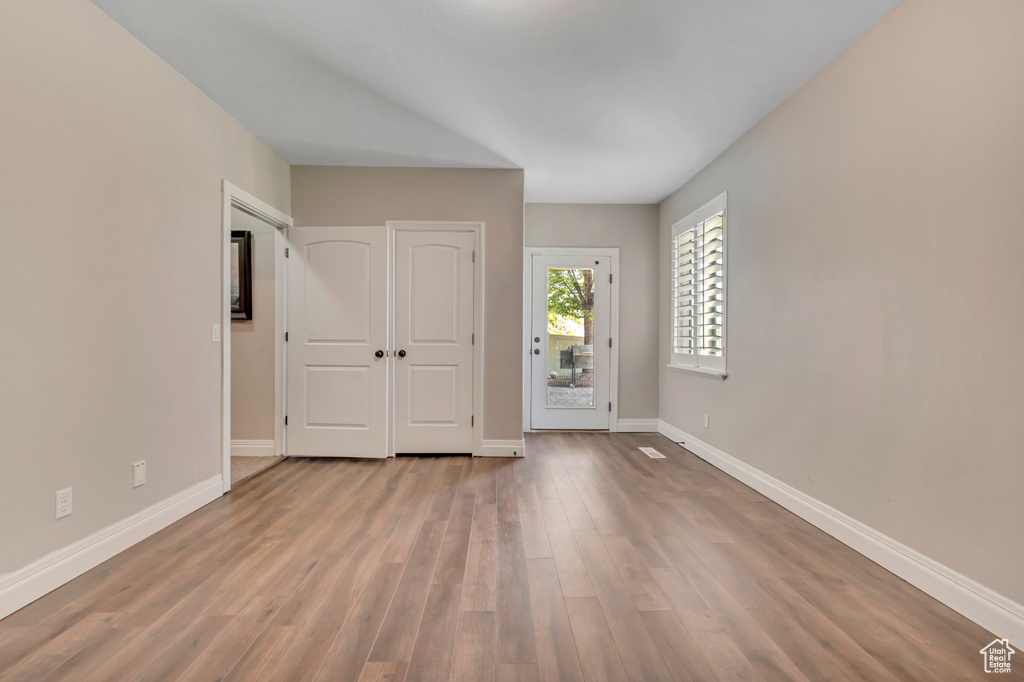 Foyer entrance with baseboards and wood finished floors