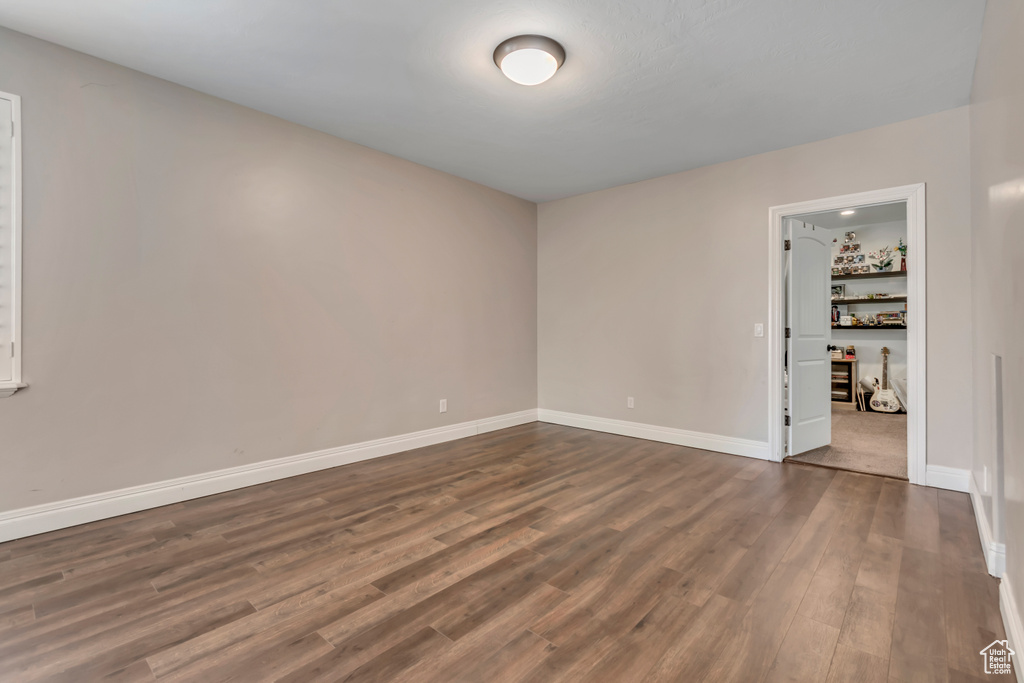 Spare room with dark wood finished floors and baseboards