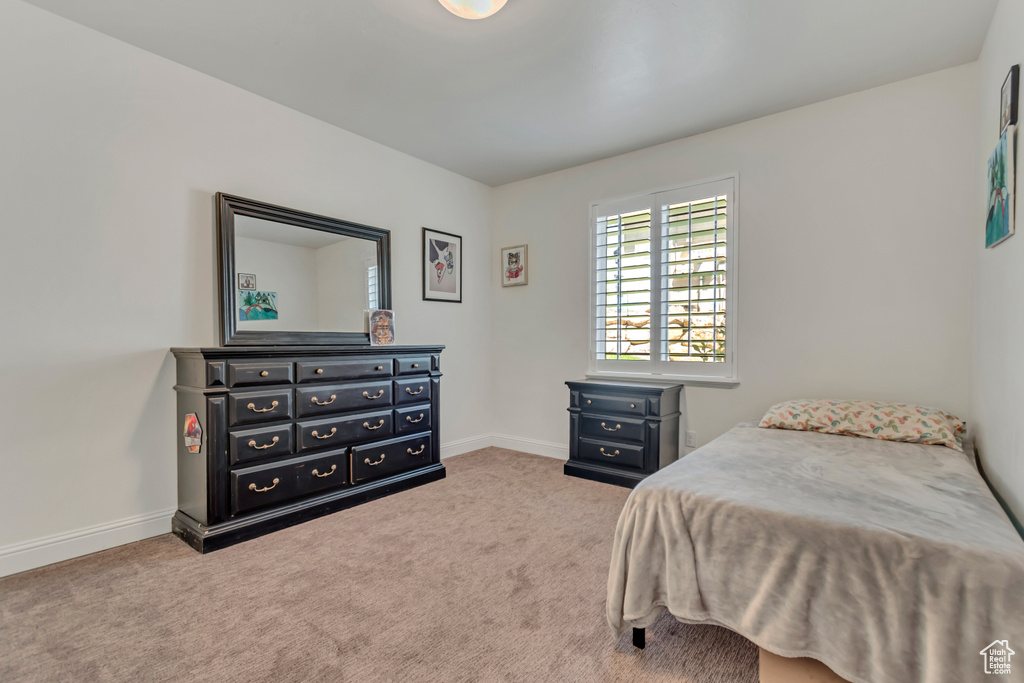 Carpeted bedroom featuring baseboards