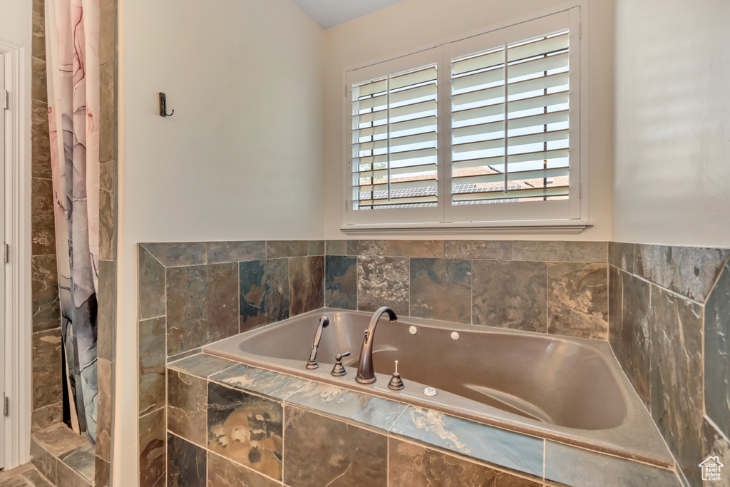 Full bathroom featuring a bath