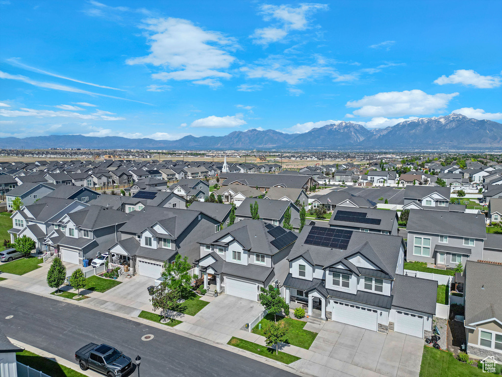 Aerial view of residential area featuring a mountainous background