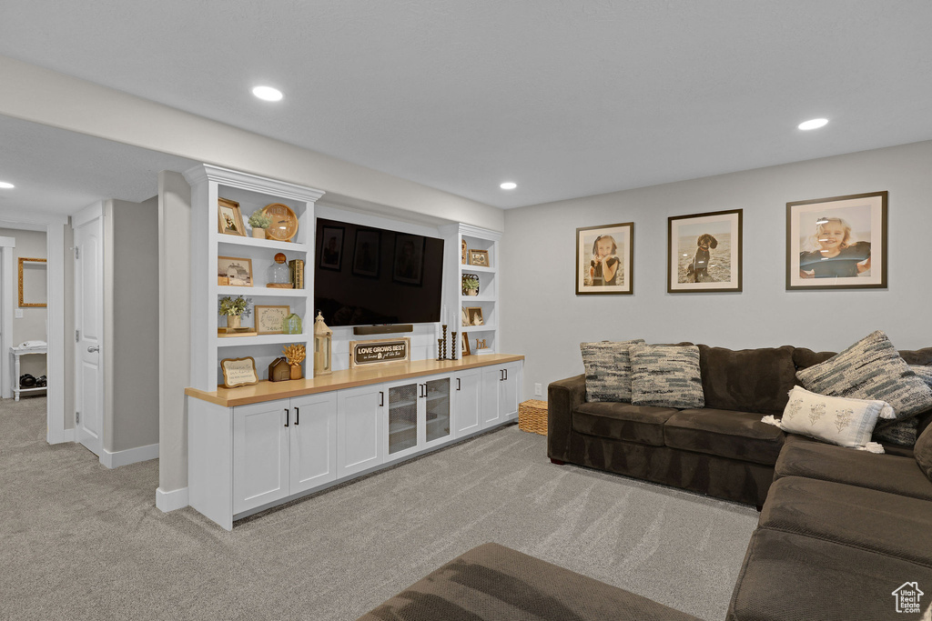 Living room with light colored carpet, recessed lighting, and baseboards
