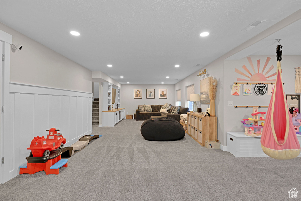 Rec room with carpet, recessed lighting, and wainscoting