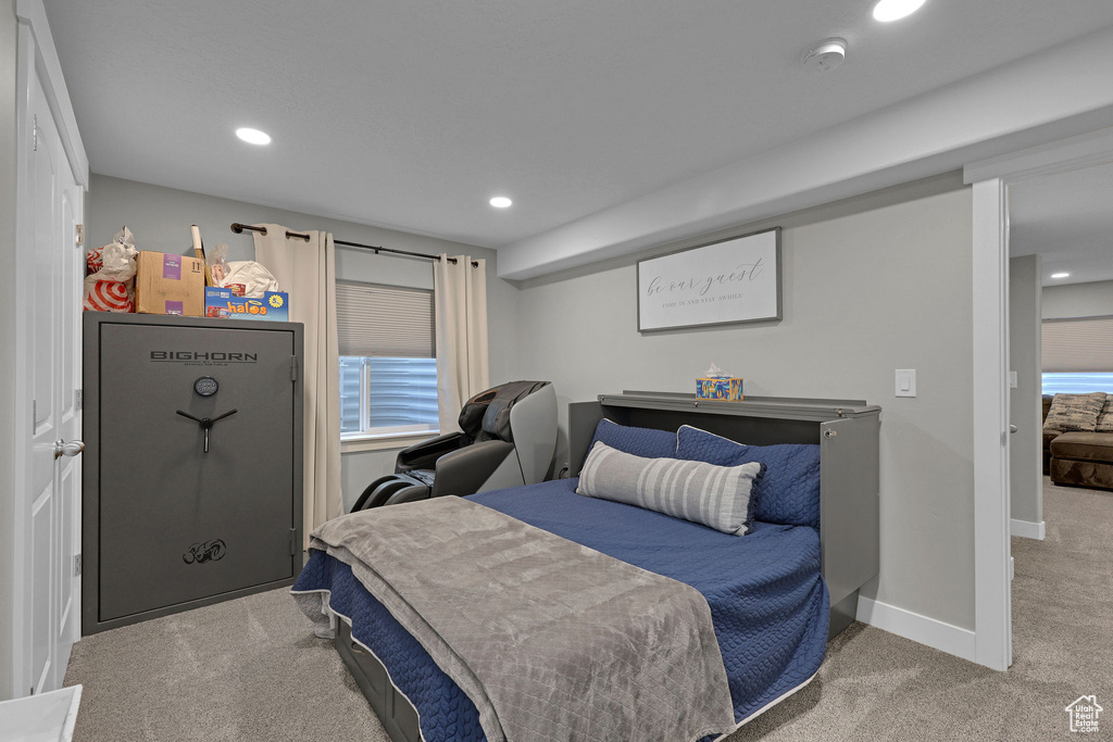 Carpeted bedroom with recessed lighting and baseboards