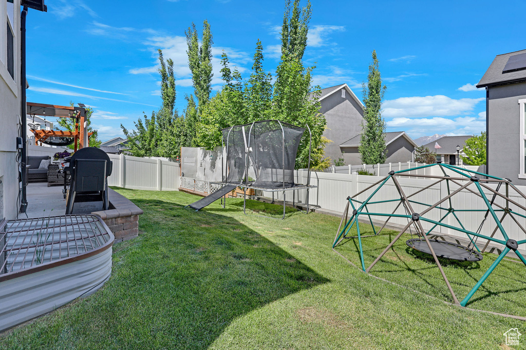 View of yard featuring a trampoline