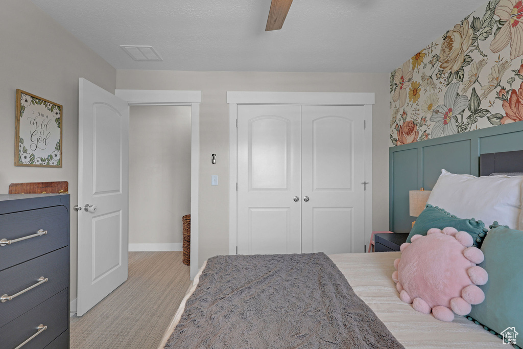 Bedroom featuring a closet, baseboards, and a ceiling fan