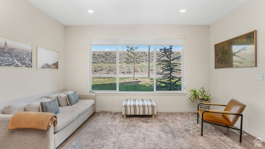 Living room with baseboards, wood finished floors, and recessed lighting