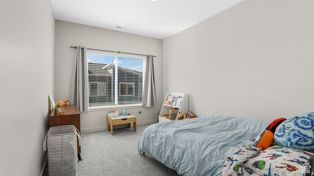 Bedroom featuring carpet flooring and baseboards