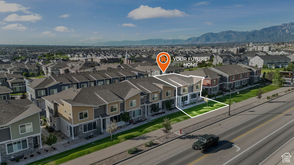 Aerial perspective of suburban area with a mountainous background