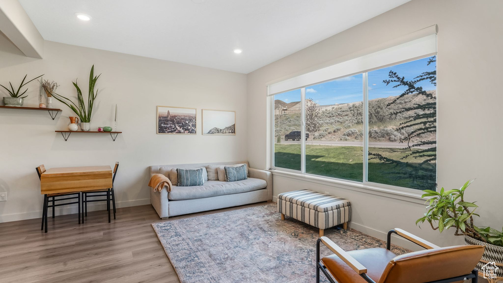 Living area with wood finished floors, baseboards, and recessed lighting