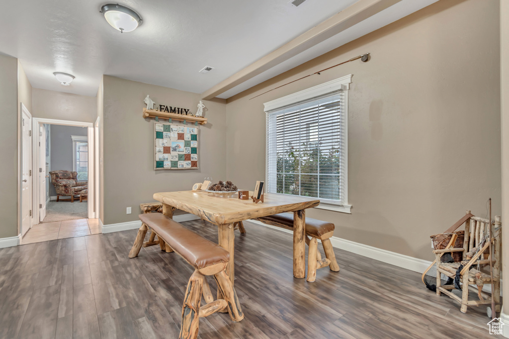 Dining space with baseboards and wood finished floors