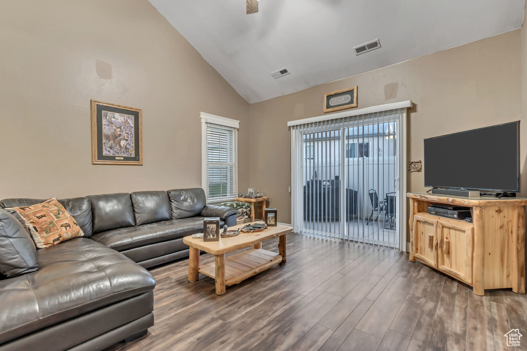 Living room featuring wood finished floors and high vaulted ceiling
