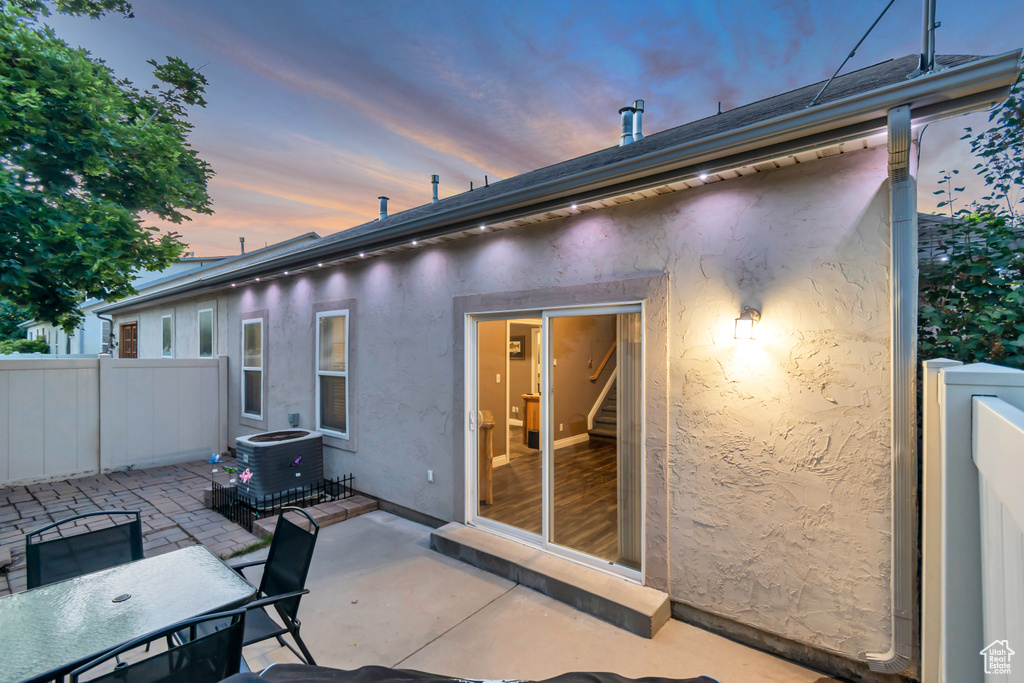 Patio terrace at dusk with a patio area and central AC unit
