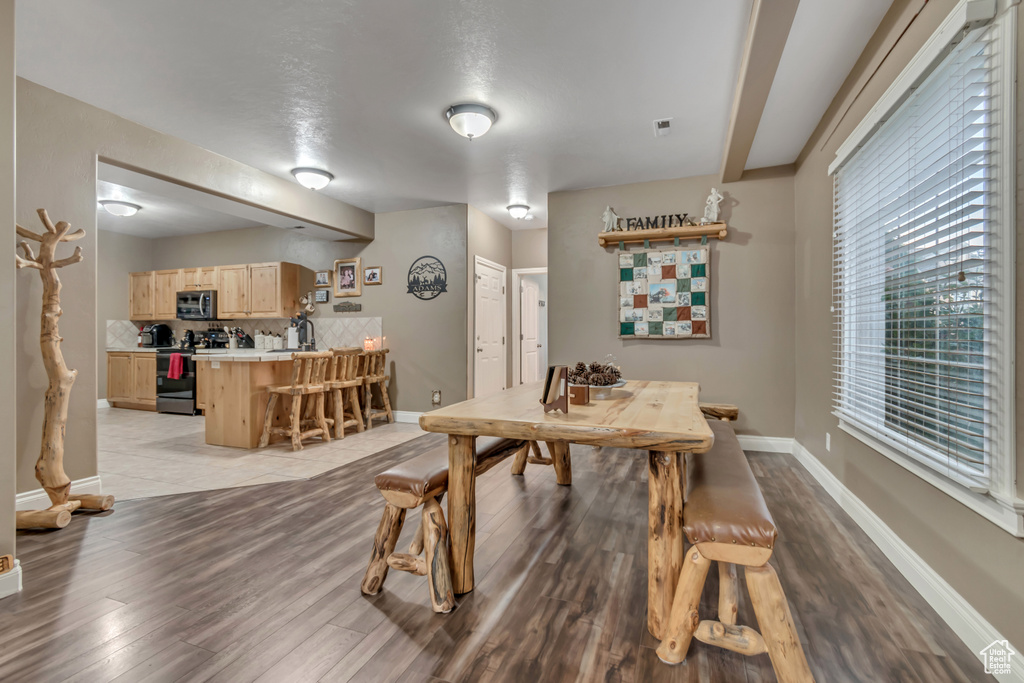 Dining area featuring light wood-type flooring and baseboards