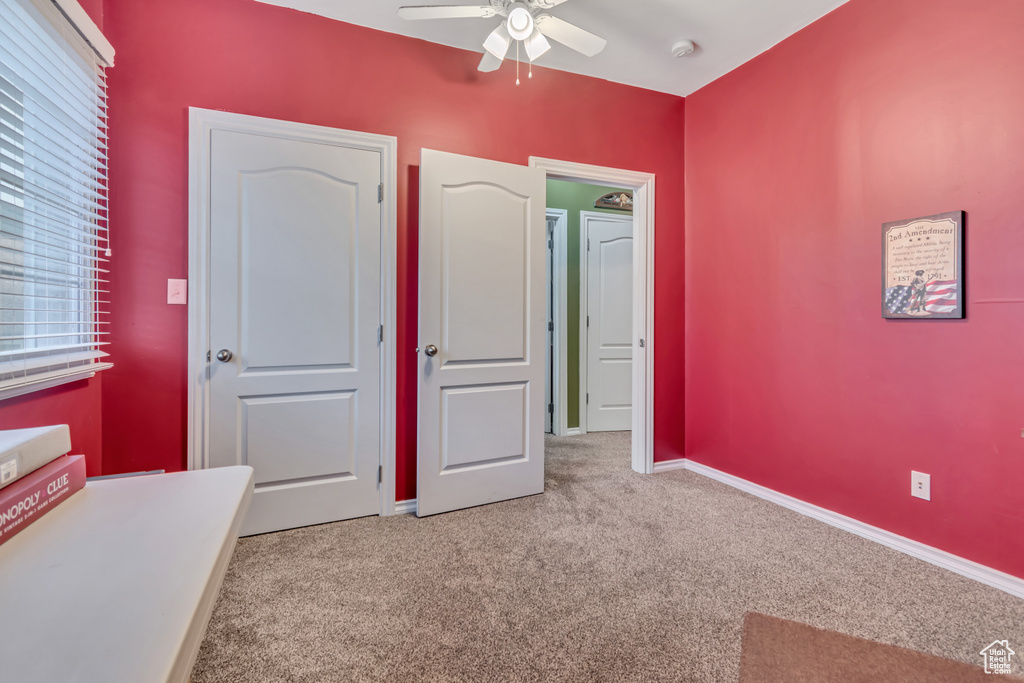 Bedroom featuring carpet and ceiling fan
