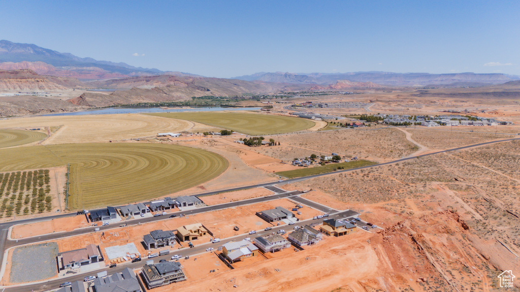 Aerial view of property and surrounding area with a water and mountain view