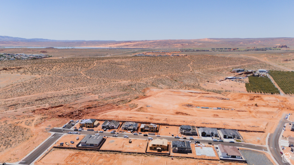 Aerial overview of property's location with a mountainous background, rural landscape, and a desert landscape
