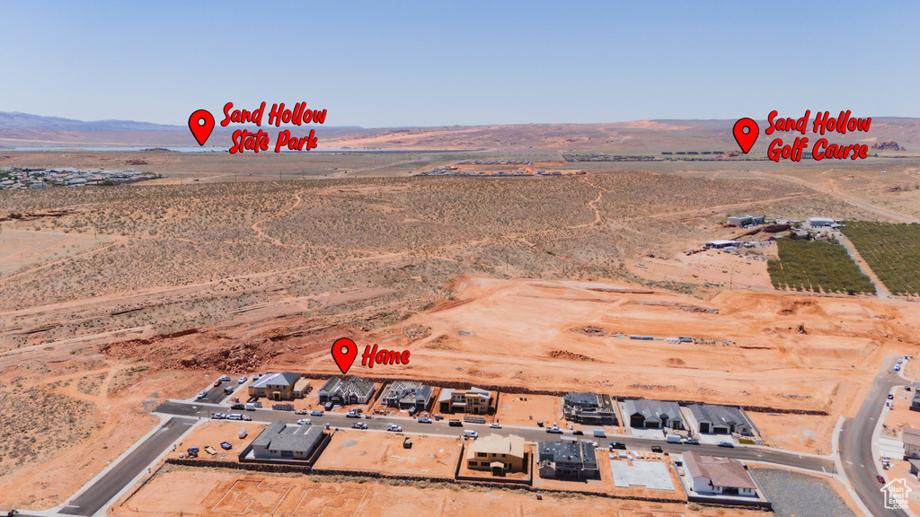 Aerial view of property's location with a mountainous background, rural landscape, and a desert landscape