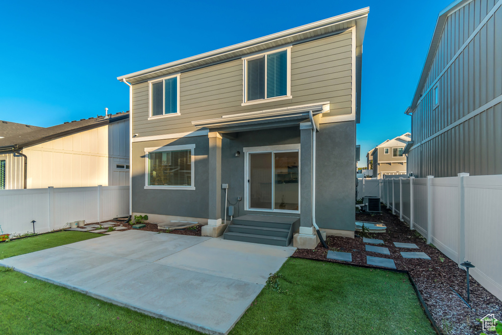 Rear view of property with a patio area and central AC unit