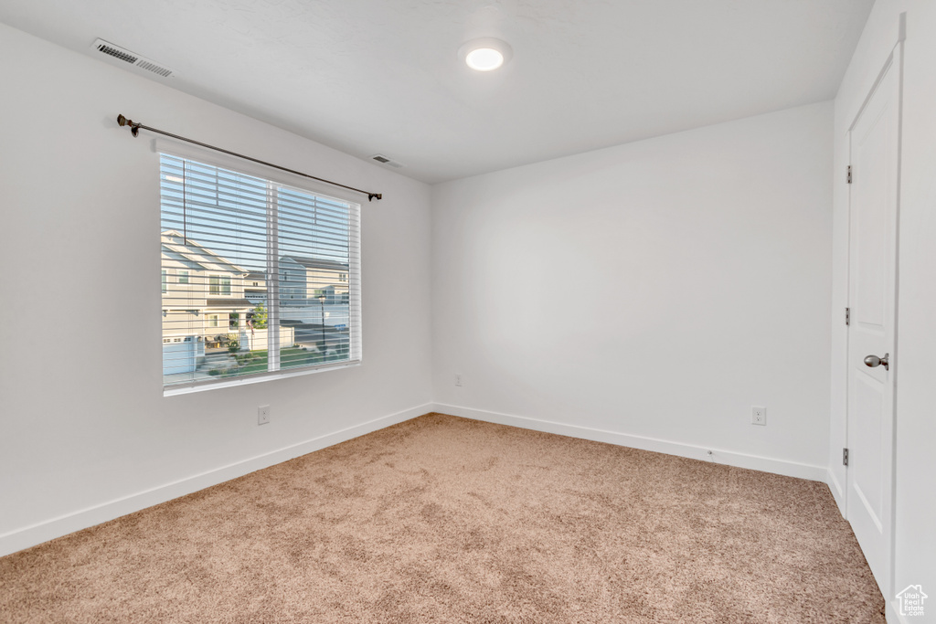 Unfurnished room with carpet flooring and baseboards