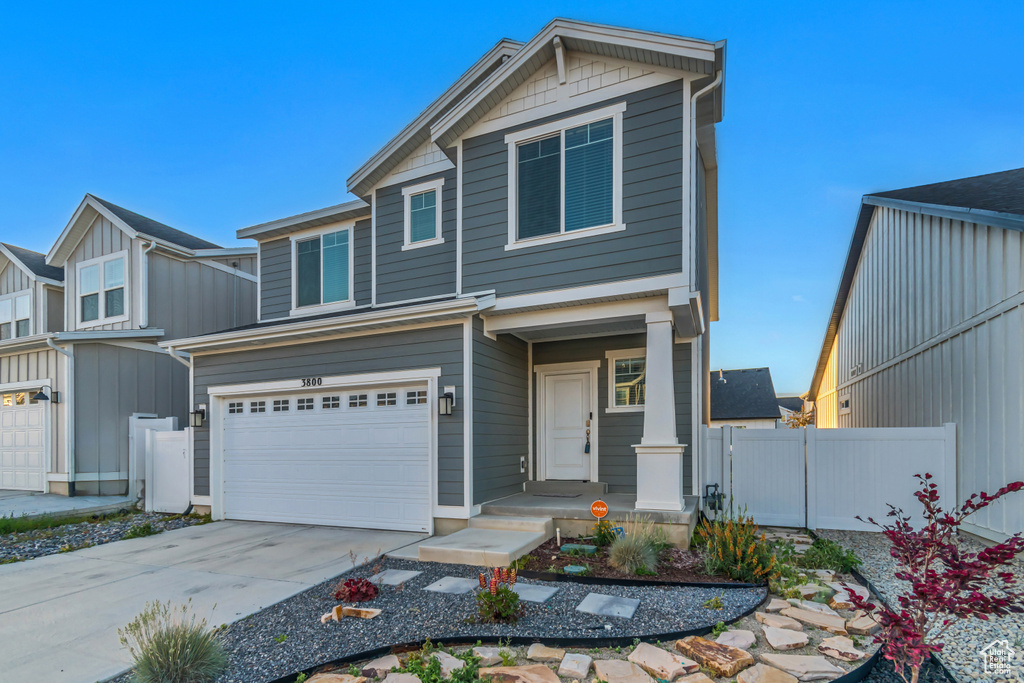 View of front of house featuring an attached garage, concrete driveway, and board and batten siding