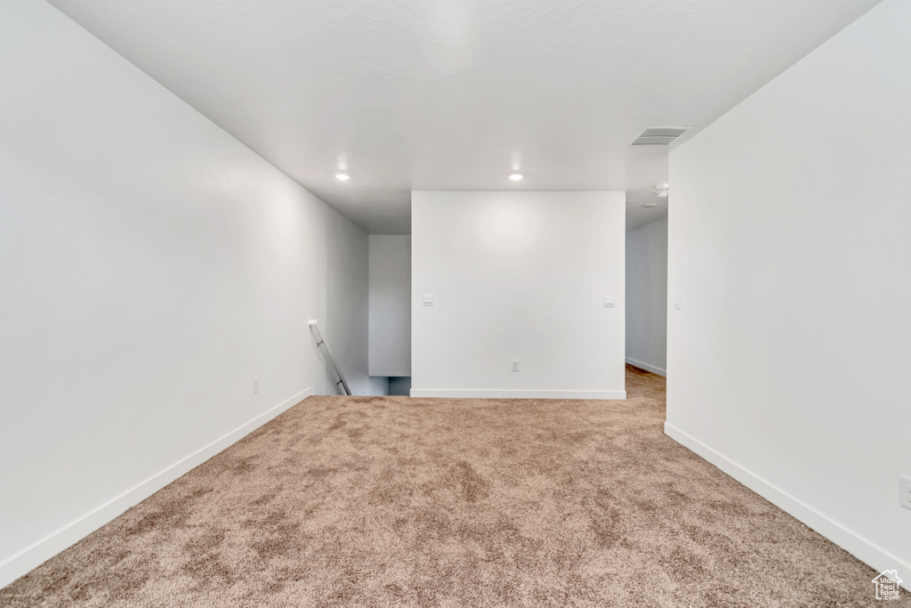 Carpeted spare room featuring baseboards and recessed lighting