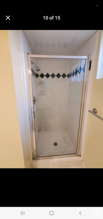 Full bathroom featuring a stall shower