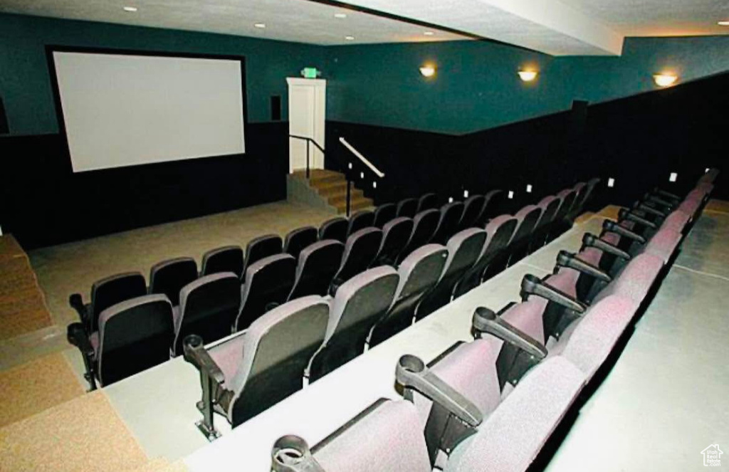 Cinema with recessed lighting and finished concrete flooring
