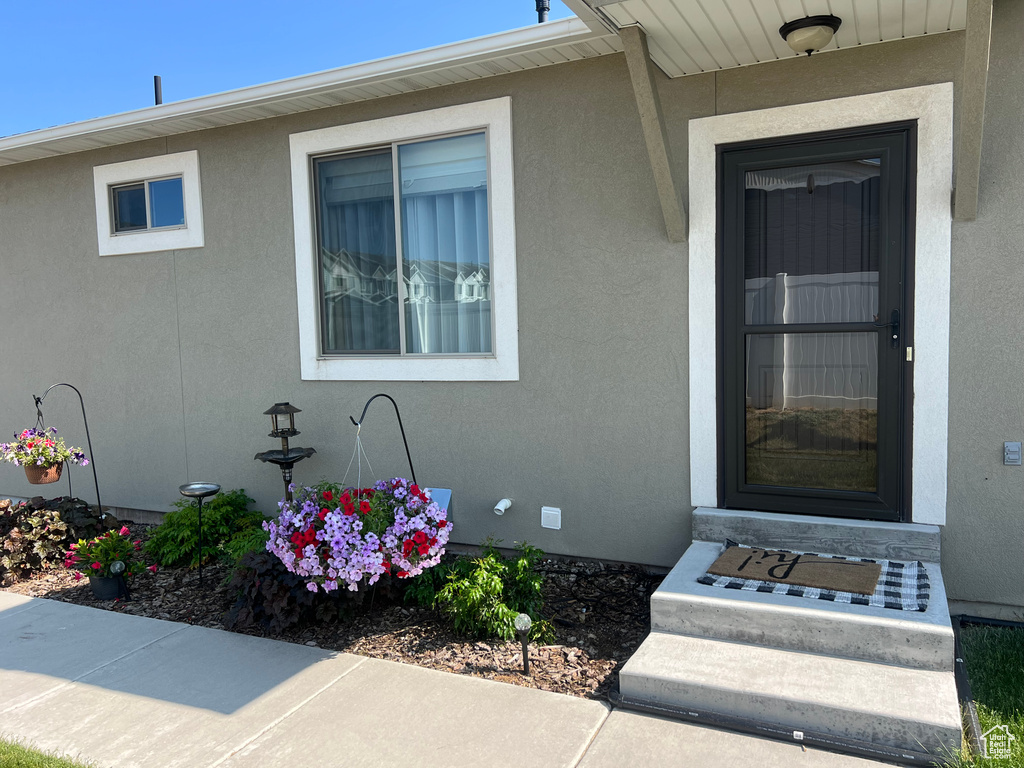 View of exterior entry featuring stucco siding