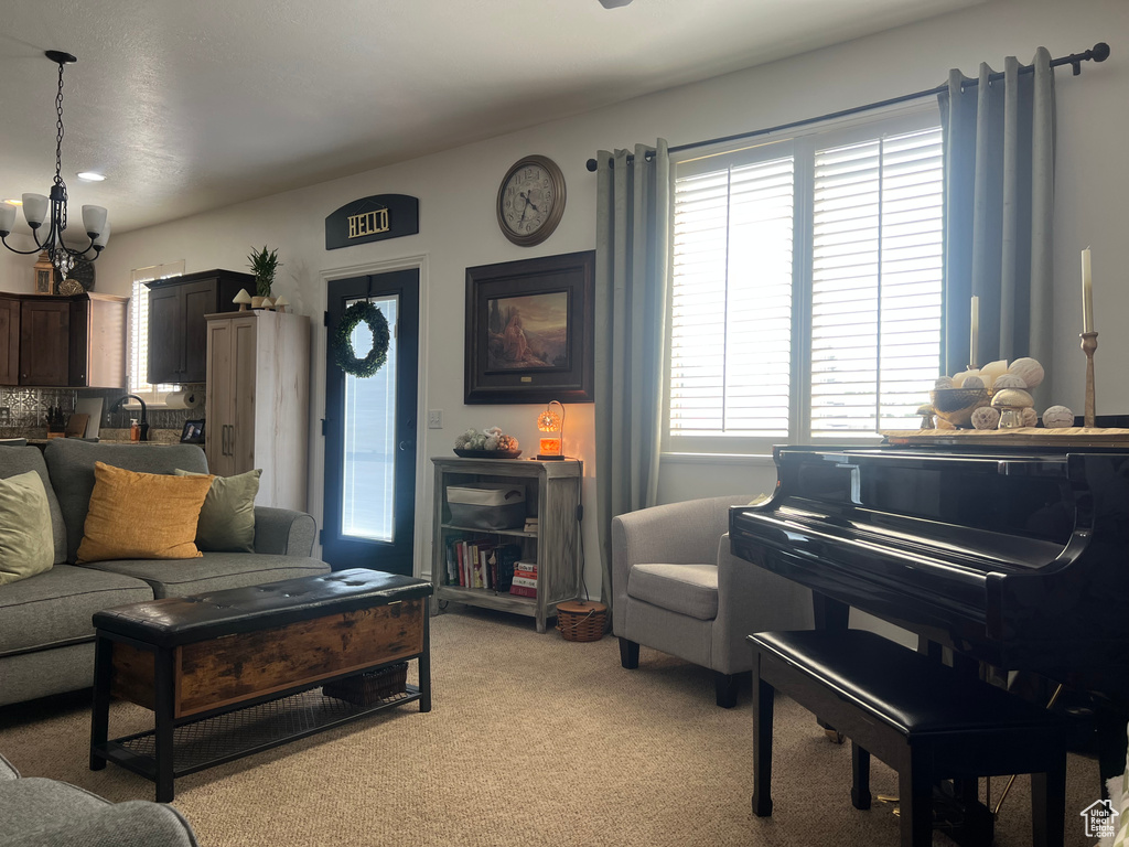 Living area with a chandelier and light colored carpet